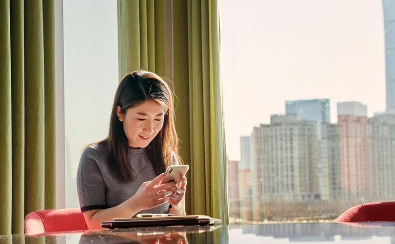 Photo of woman reading an InMail on her phone